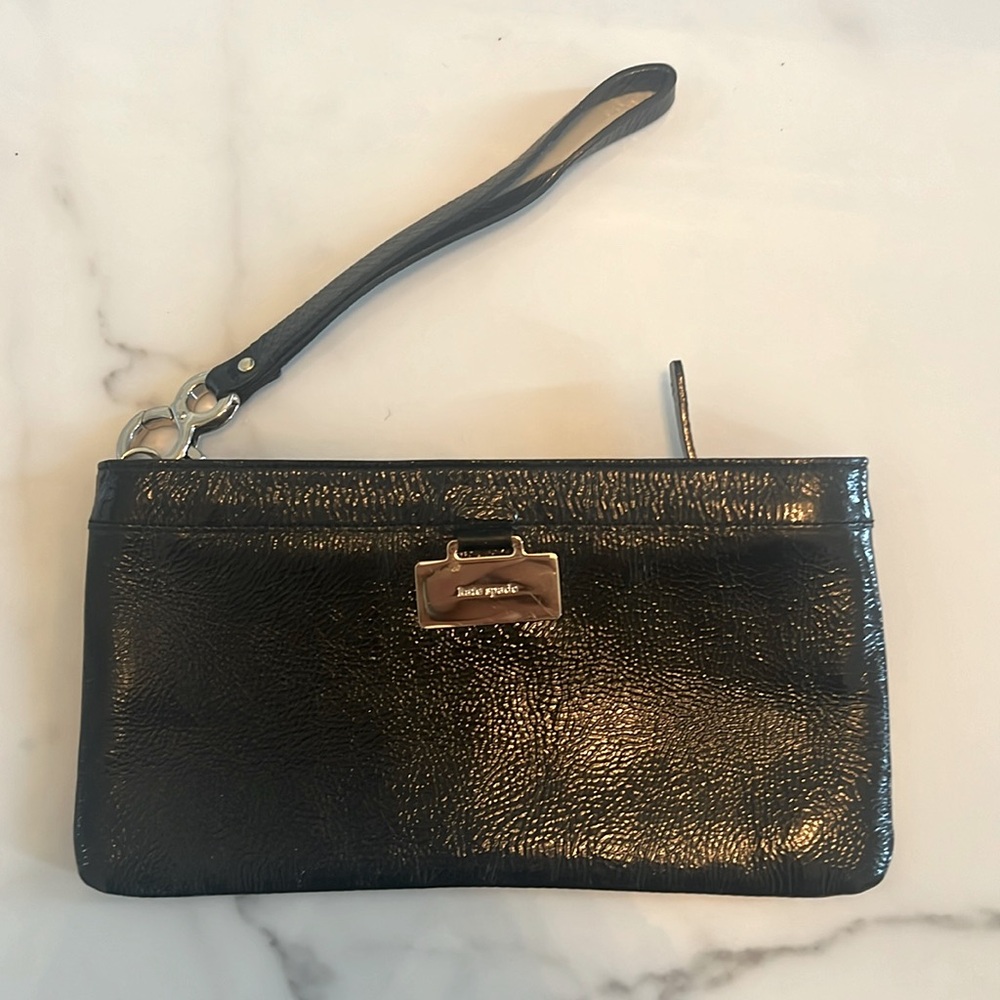 Kate Spade - Black patent leather with metal tag